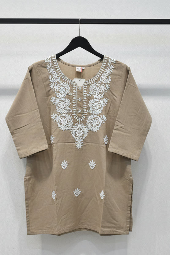 Brown outfit with white floral patterns on a tiled floor