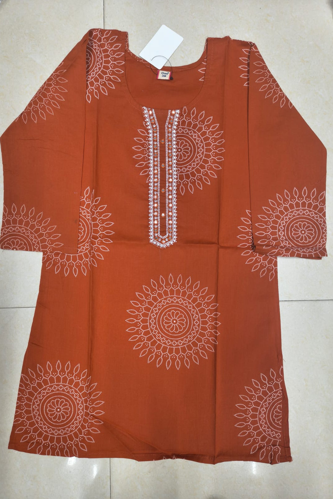 Orange top with white patterns